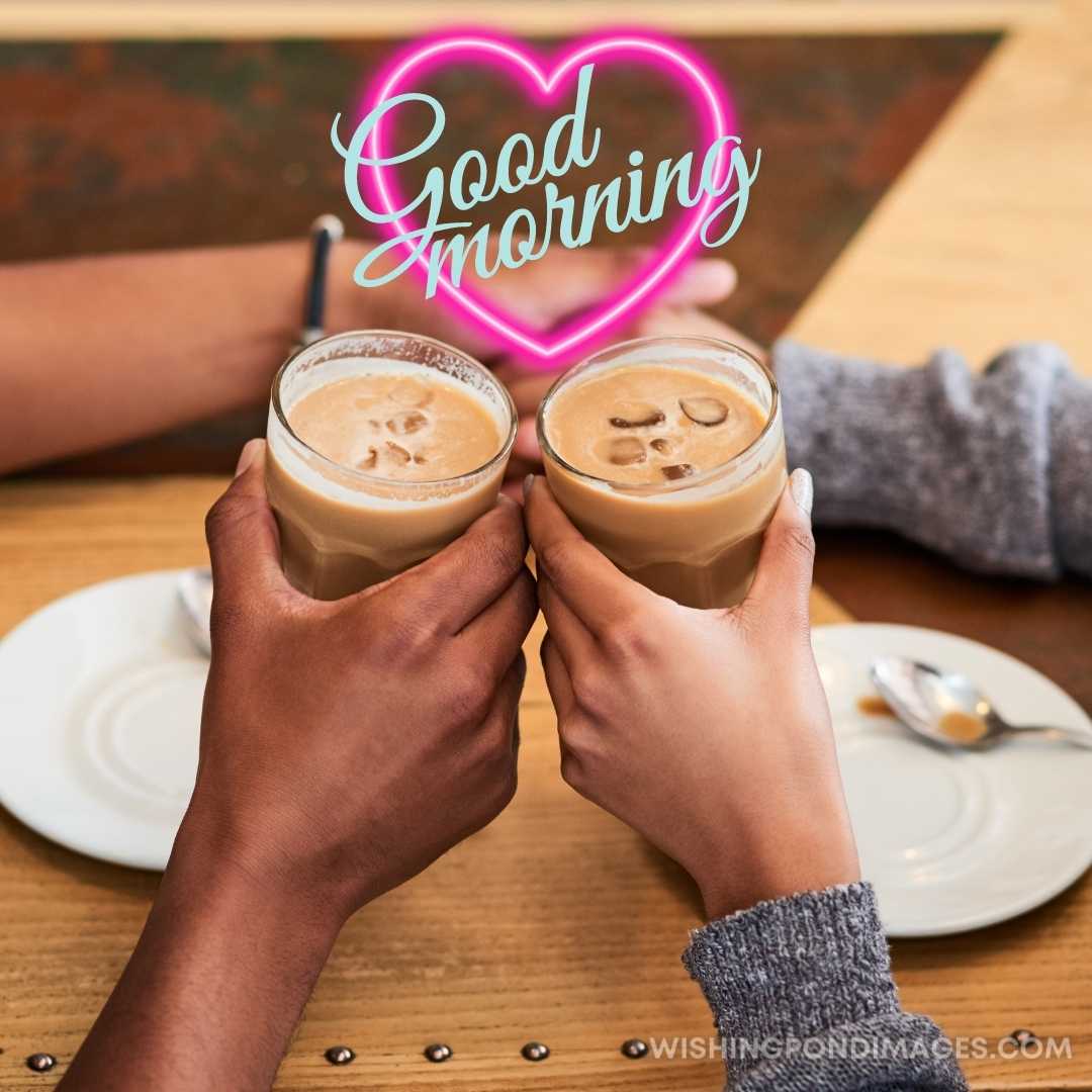 Couple holding coffee glasses in hands in the cafe. Good Morning Coffee Images